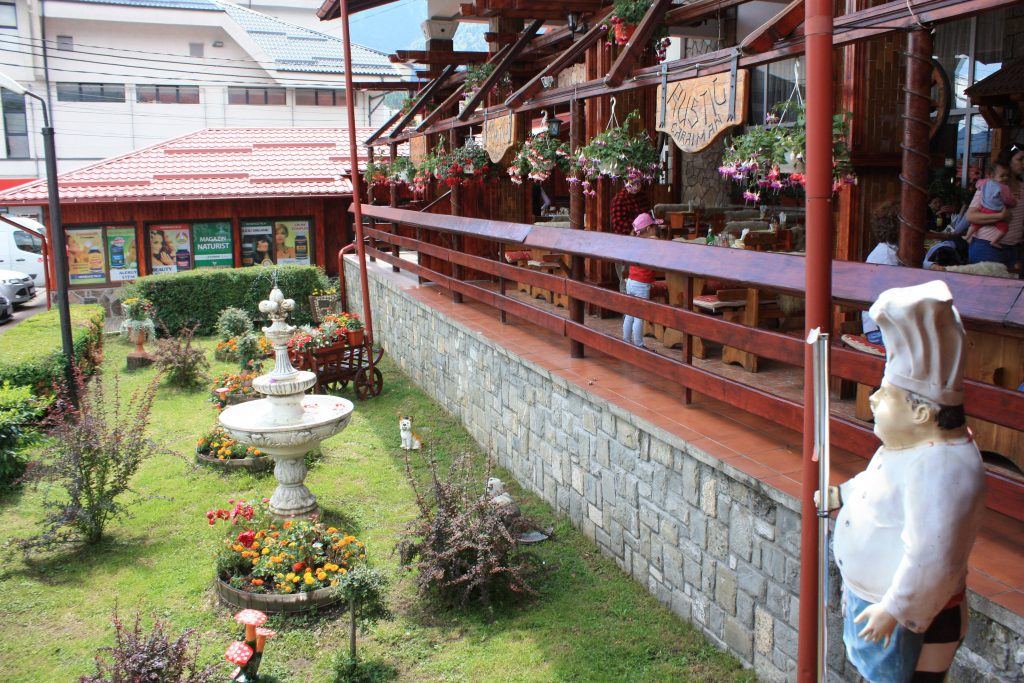 The Rustic restaurant terrace, with a pergola and outdoor seating